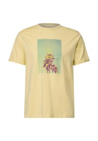 Lyhythihainen puuvillapaita vaaleankeltaisena, jossa on graafinen printti palmuista purppuran ja sinisen sävyissä suorakulmaisen kehän sisällä.