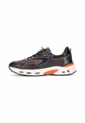 Zapatilla deportiva marrón oscuro y azul marino con detalles naranjas, suela blanca acolchada con orificios de aire, cordones negros y el logo de Pikolinos en el lateral.