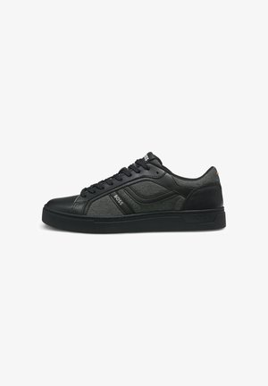 Black low-top sneaker with lace-up closure, textured fabric and leather panels, and "BOSS" branding on side and tongue.