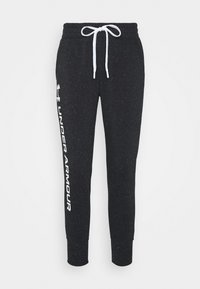 Zwarte joggings met een wit gesprenkeld patroon en een elastische tailleband. Heeft een witte merklogo dat verticaal langs de zijkant is gedrukt.