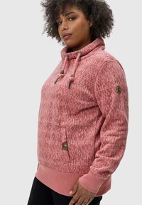 Rose-colored hooded sweatshirt with textured pattern, drawstrings, and side pocket; ribbed cuffs and hem add structure.