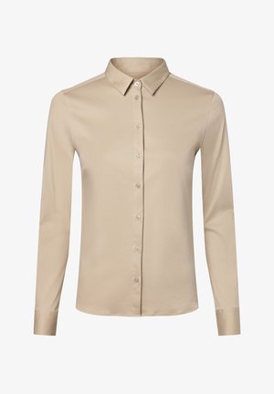 Camicia beige a maniche lunghe con bottoni, colletto appuntito e polsini con un solo bottone, mostrata su sfondo bianco.