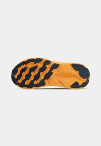 Rubber shoe sole with an orange base and black tread pattern. Features raised textures for traction and stability. Rounded edges and grooves present.