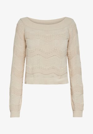 Suéter de punto beige con mangas largas, escote barco amplio y un patrón texturizado en ondulación. Puños y dobladillo acanalados. Largo recortado.