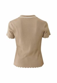 Beige geribbelde gebreide top met een geschulpte zoom en korte mouwen. Heeft een klassieke kraag met een contrasterende witte bies.