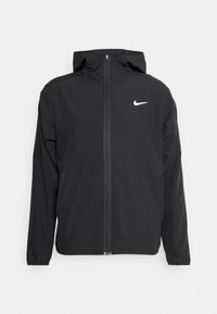 Black zip-up hooded jacket with long sleeves and white Nike logo on the left chest, displayed on a light background.