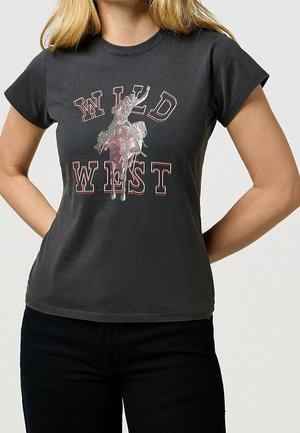 Black cotton t-shirt featuring a graphic print with "WILD WEST" text and a horse rider design in shades of pink and gray. Short sleeves.