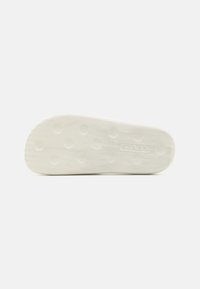 White rubber sole with a textured, ridged surface and circular grip patterns. "Levi's" logo embossed on the side.