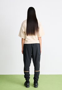 New Balance CLASSICS JOGGER - Tracksuit bottoms - black