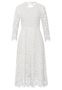 Bílé krajkové šaty s dlouhými rukávy, kulatým výstřihem a rozšířenou sukní. Krajkový vzor s květinovými motivy a vykrojenými okraji na lemu.