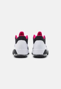 Białe buty sportowe z czarnymi i różowymi akcentami, wykonane z gładkiego materiału, z wyściełanym kołnierzem wokół pięty i widoczną amortyzacją powietrzną w podeszwie.