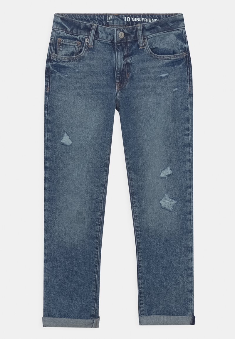 Jean en denim bleu avec légère usure, revers roulés, bouton et fermeture éclair à l'avant, et design à cinq poches.