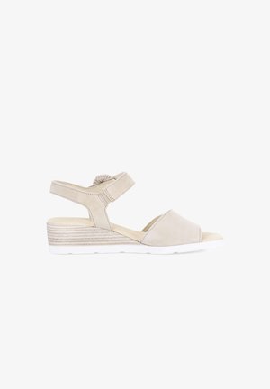 Beige wedge sandal with open toe, adjustable ankle strap, and textured midsole, designed for casual or dress wear.