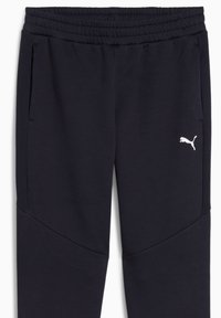 Navy sweatpants med ribbet talje, sidelommer og hvid Puma-logo. Lavet af blødt stof med en glat tekstur og tapered design.