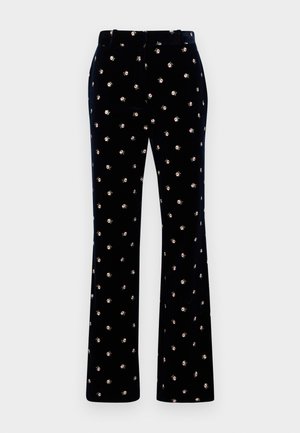 Black velvet pants with small white and pink floral pattern, belt loops, and straight legs on a white background.