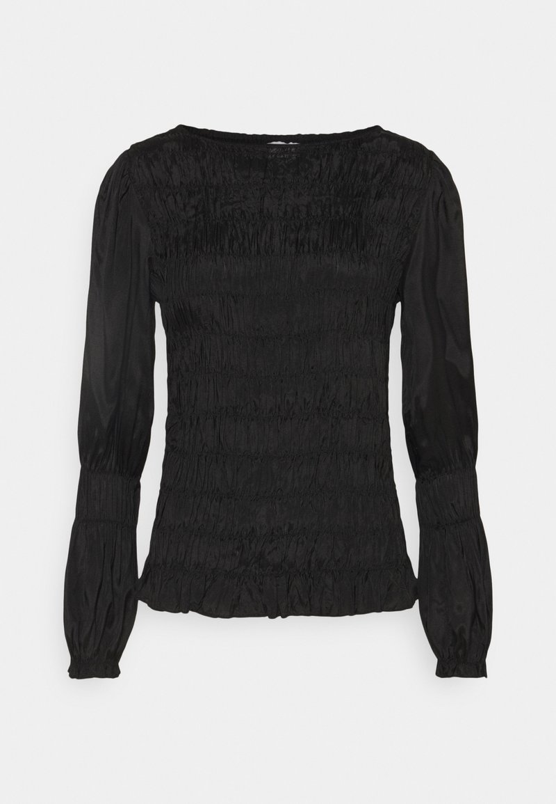 Blouse noire à manches longues avec corps smocké, manches bouffantes et poignets élastiques, avec un col rond et un ourlet à volants subtil.