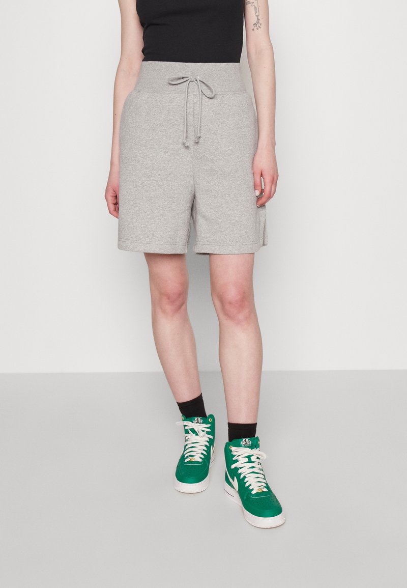 Gray cotton blend shorts with an elastic waistband and drawstring, featuring side pockets and a relaxed fit, paired with green high-top sneakers.