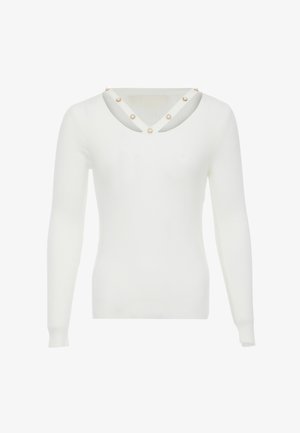 Hvid ribbet langærmet sweater med en dyb V-hals, guldaccentuerede udskæringer og runde udsmykninger langs halsudskæringen.