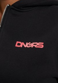 Black zip-up hoodie with a smooth texture; features a prominent pink embroidered logo "DNGRS" on the chest area.