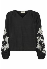 Blouse noire avec de longues manches bouffantes. Design en V. Présente une broderie de feuilles blanches sur les manches. Tissu léger et texturé.