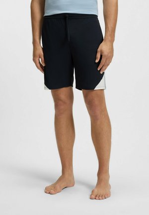 Schwarze Badeshorts aus leichtem Material mit einem verstellbaren Bund und einem Akzentfarbenelement an der Seite.