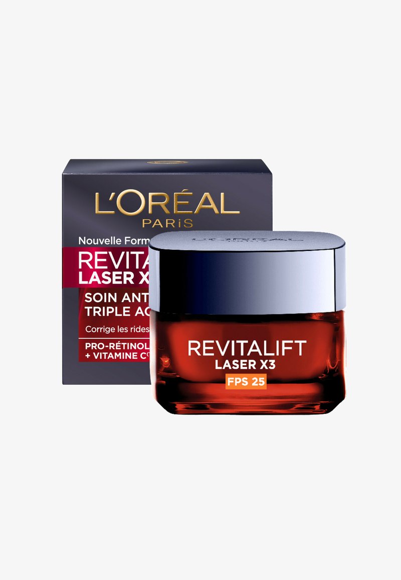 Crème Revitalift Laser X3 dans un pot transparent orange avec un couvercle métallique argenté, emballée dans une boîte noire et rouge avec un texte blanc.