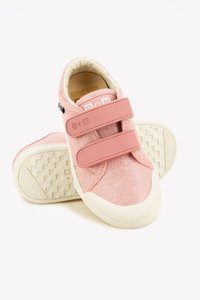 Pink textile sneakers featuring a textured upper, two velcro straps, and a rubber outsole with a grid pattern for traction.