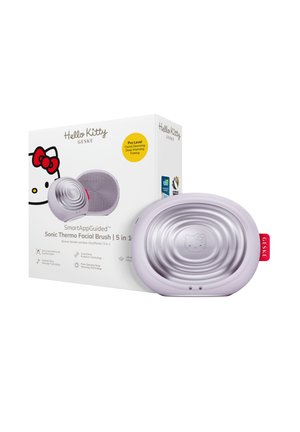 Brosse faciale thermo-sonique ovale Hello Kitty couleur lavande avec un emballage mettant en avant les fonctions 5 en 1 : nettoyage, chauffage et raffermissement.