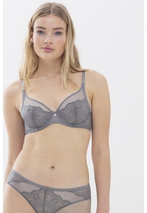 Gray lace bra with sheer detailing, featuring floral patterns, adjustable straps, and a small decorative center accent. Matching gray underwear visible.