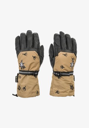 Ein Paar tanfarbene und schwarze Gore-Tex-Handschuhe mit verstellbaren Riemen, schwarzen Vogel- und Sternmotiven auf dem tanfarbenen Stoff und strukturierten schwarzen Lederfingern.