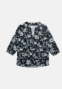 Merine blouse valge lillemustriga. Eespool on poolne tõmblukk ja 3/4-sleeves koos kogutud detailidega, et saavutada mugav istuvus.