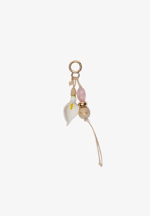 Keychain with a gold ring, a white calla lily charm, and two decorative beads in pink and beige tones on a beige cord.