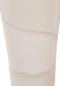 Svijetlo bež atletske tajice izrađene od glatkog, rastezljivog materijala s teksturiranim mrežastim panelom u zakrivljenom dizajnu na donjem dijelu bočne strane.