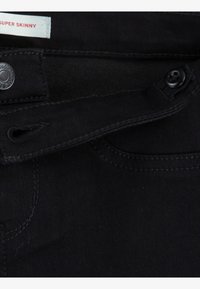 Blugi negri super skinny cu o textură netedă, prevăzuți cu închidere cu nasture metalic, bucle pentru curea și detalii cusute de-a lungul buzunarelor.