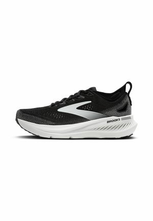 Zapatillas deportivas negras con parte superior de malla, suela blanca y detalles plateados reflectantes. Cuenta con un cuello acolchado y diseño con cordones.