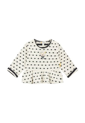 Maglietta a maniche lunghe di colore crema con pois neri, caratterizzata da un orlo arricciato e un design di orsetto ricamato sulla parte anteriore, con polsini a contrasto.