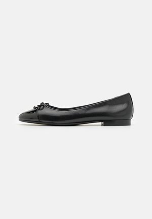 Black leather ballet flats with a rounded toe, textured finish, and bow detail at the front. Low-profile heel for comfort.