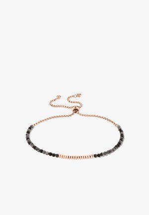 Bracelet ajustable en or rose avec des perles alternées petites noires et en or rose, présenté sur un fond blanc.