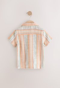 Short-sleeved shirt featuring striped patterns in peach, blue, and white, made from a textured fabric, with a classic collar and open back.