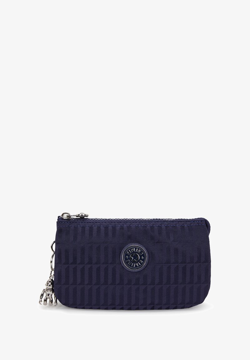 Navy patterned fabric wallet with a zip closure, silver hardware, and a decorative charm. Features a round logo on the front.