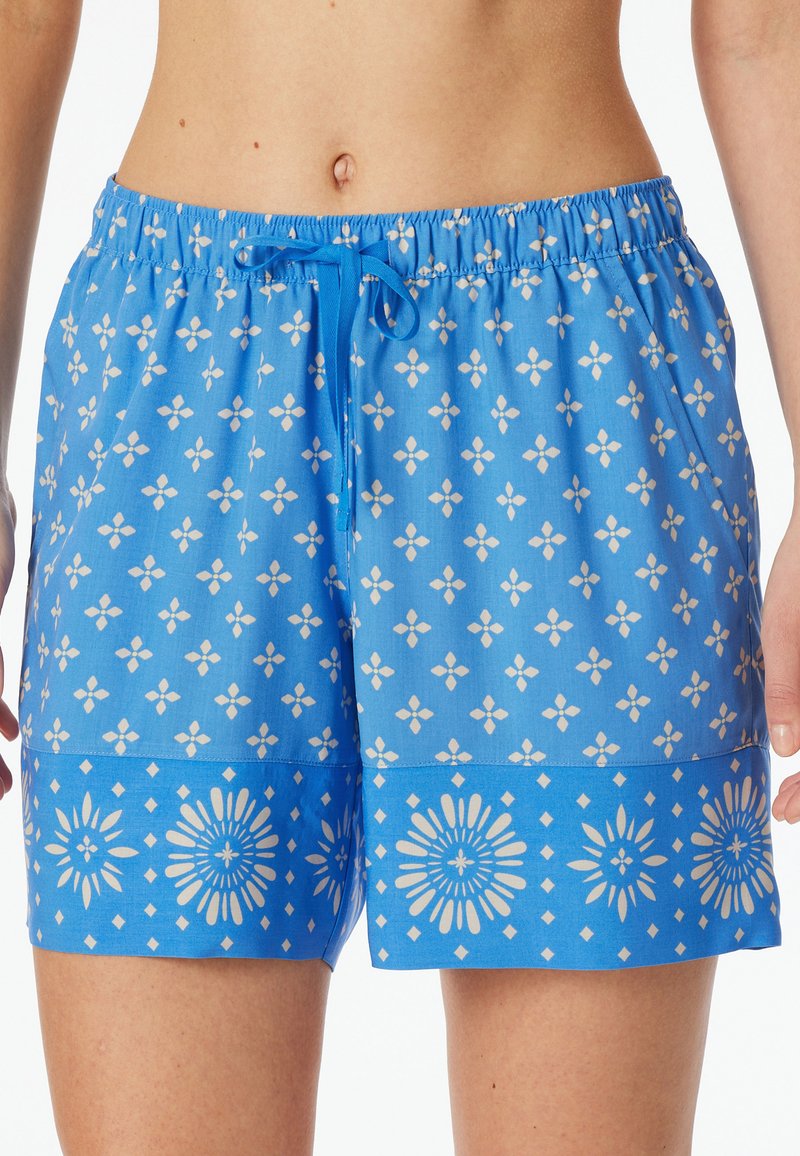 Blaue Shorts mit Muster und Blumenmotiv, elastischem Bund und Kordelzug. Der untere Saum zeigt ein kontrastierendes florales Motiv in Weiß.