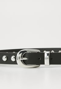 Black leather belt featuring a silver metal buckle, domed studs along the strap, and multiple adjustment holes for sizing.