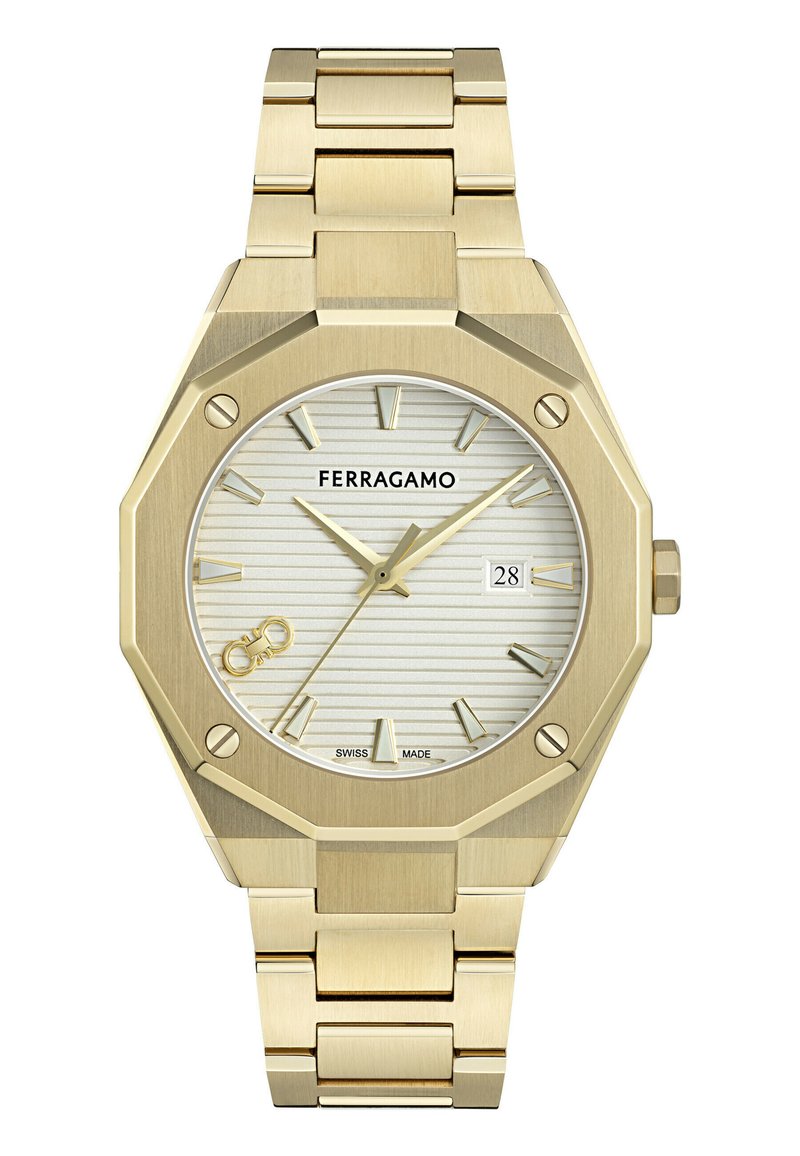 Reloj de acero inoxidable dorado con una caja octagonal, esfera blanca texturizada, marcadores de hora dorados y una pantalla de fecha a las tres en punto.