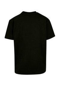 Černé bavlněné tričko s krátkým rukávem, kulatým výstřihem a volným střihem. Hladká textura bez viditelných grafik nebo vzorů.
