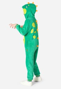 Zelený fleece overal s kapucňou. Obsahuje žlté a oranžové akcenty v tvare šupín, bočné vrecká a rebrované manžety. Mäkká textúra a dizajn dinosaura.