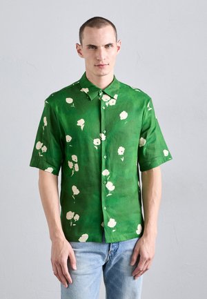 Short-sleeve green shirt made of lightweight fabric, featuring a floral pattern in cream with buttons and a pointed collar.