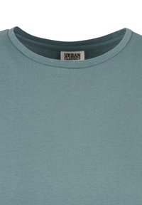 Herrtröja med rund hals i ljus teal, tillverkad av mjuk bomull. Texturerad, slät tyg med minimal sömnad och en liten etikett inuti.
