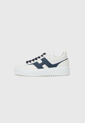 White sneakers with navy accents, smooth leather upper, round toe, padded collar, white ridged sole, and black laces featuring a logo on the side.