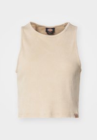 Beige ribbad linne med rund halsringning, kort skärning och en liten logotags vid fållen. Tyget har en mjuk textur.