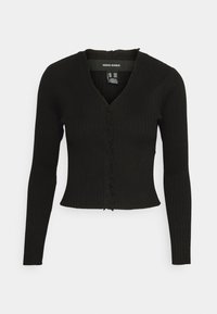 Top nero a coste con maniche lunghe, scollo a V e bordo arricciato testurizzato lungo il pattino. Design aderente e lunghezza cropped.